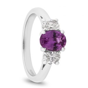 oval pink sapphire with oval diamonds as platinum 3 stone ring